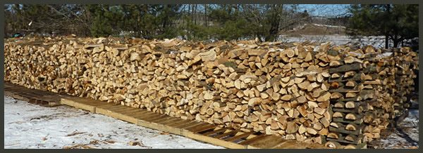 Example of stacks of firewood available for sale.